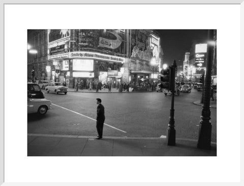 Lone man in Piccadilly at night 1960