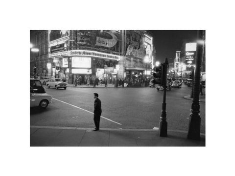 Lone man in Piccadilly at night 1960