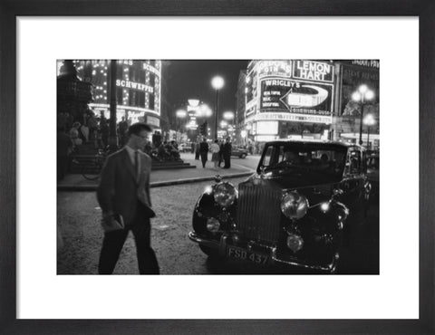 A man cuts across traffic at Piccadilly Circus 1960