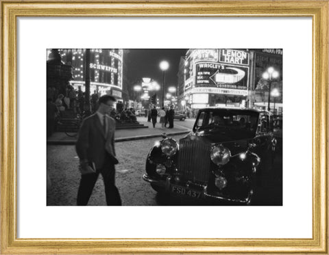 A man cuts across traffic at Piccadilly Circus 1960