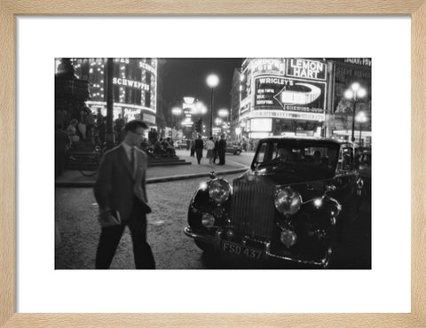 A man cuts across traffic at Piccadilly Circus 1960