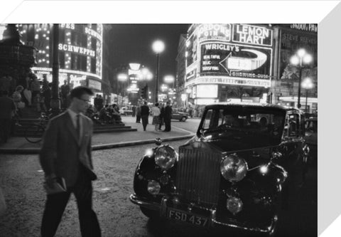 A man cuts across traffic at Piccadilly Circus 1960