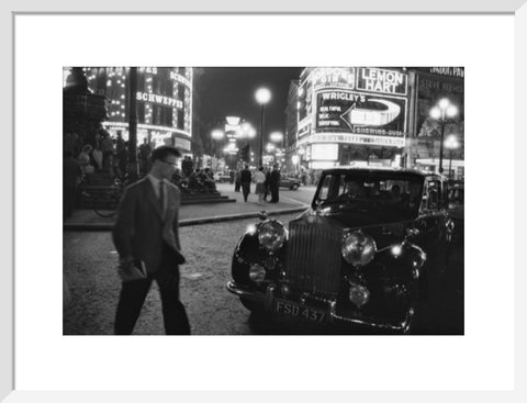 A man cuts across traffic at Piccadilly Circus 1960