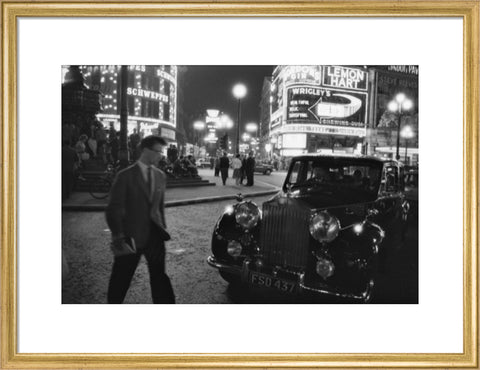 A man cuts across traffic at Piccadilly Circus 1960