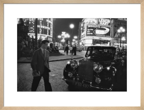 A man cuts across traffic at Piccadilly Circus 1960