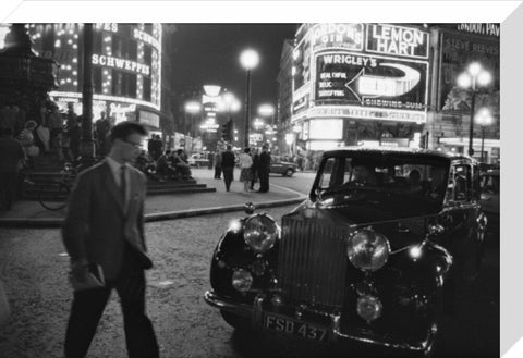 A man cuts across traffic at Piccadilly Circus 1960