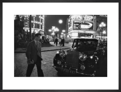 A man cuts across traffic at Piccadilly Circus 1960