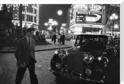 A man cuts across traffic at Piccadilly Circus 1960