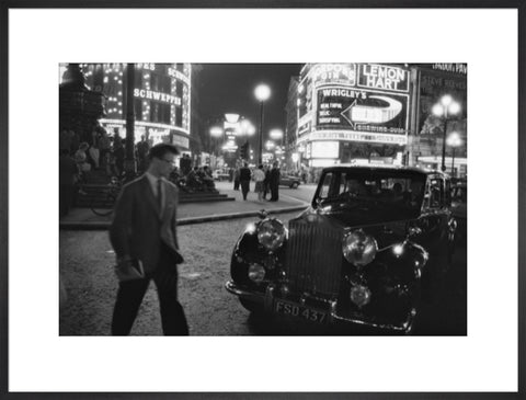 A man cuts across traffic at Piccadilly Circus 1960