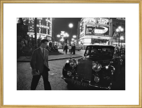 A man cuts across traffic at Piccadilly Circus 1960