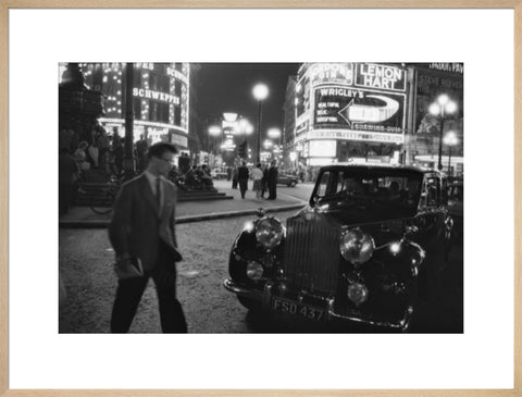 A man cuts across traffic at Piccadilly Circus 1960