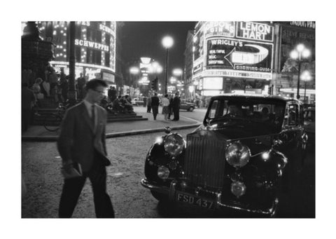 A man cuts across traffic at Piccadilly Circus 1960