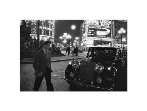 A man cuts across traffic at Piccadilly Circus 1960