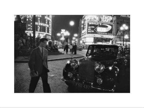 A man cuts across traffic at Piccadilly Circus 1960