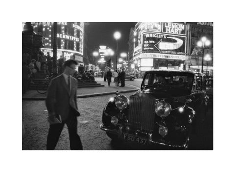 A man cuts across traffic at Piccadilly Circus 1960