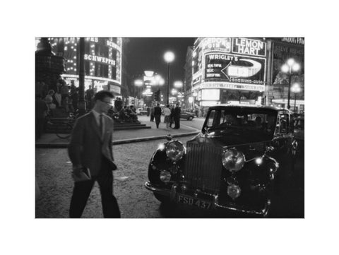 A man cuts across traffic at Piccadilly Circus 1960