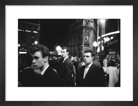 Passers-by on a London street at night c.1955