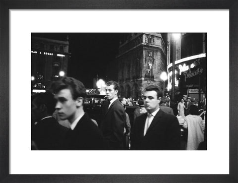 Passers-by on a London street at night c.1955
