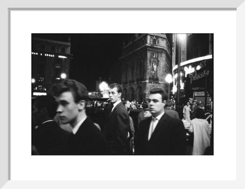 Passers-by on a London street at night c.1955