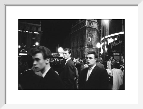 Passers-by on a London street at night c.1955