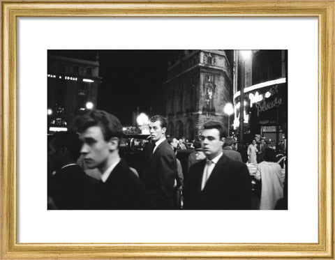 Passers-by on a London street at night c.1955