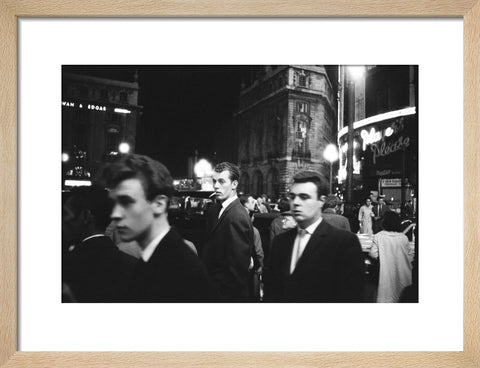 Passers-by on a London street at night c.1955