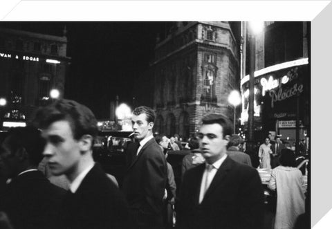 Passers-by on a London street at night c.1955