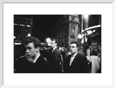 Passers-by on a London street at night c.1955