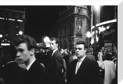 Passers-by on a London street at night c.1955