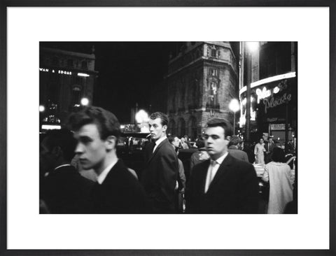 Passers-by on a London street at night c.1955