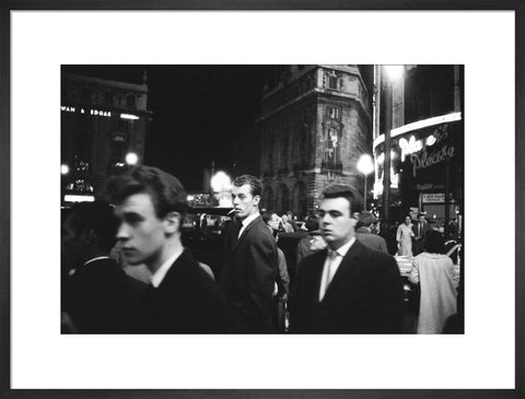 Passers-by on a London street at night c.1955