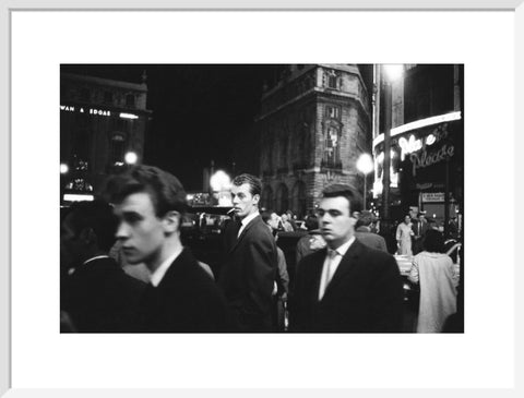 Passers-by on a London street at night c.1955