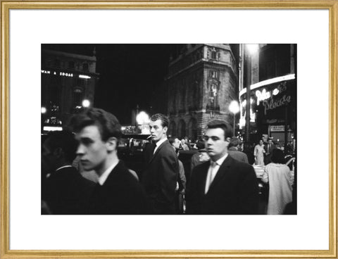 Passers-by on a London street at night c.1955