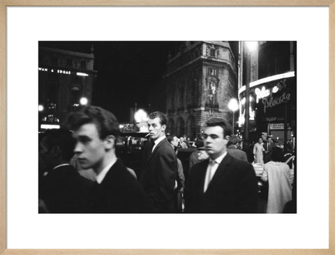 Passers-by on a London street at night c.1955