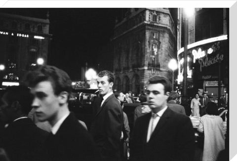 Passers-by on a London street at night c.1955