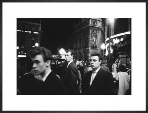 Passers-by on a London street at night c.1955