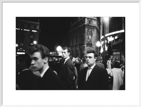 Passers-by on a London street at night c.1955