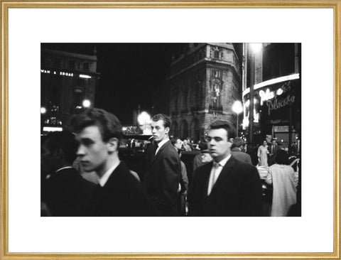 Passers-by on a London street at night c.1955