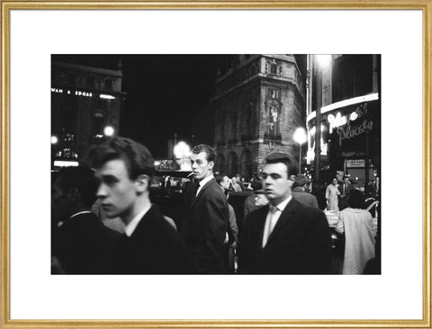 Passers-by on a London street at night c.1955