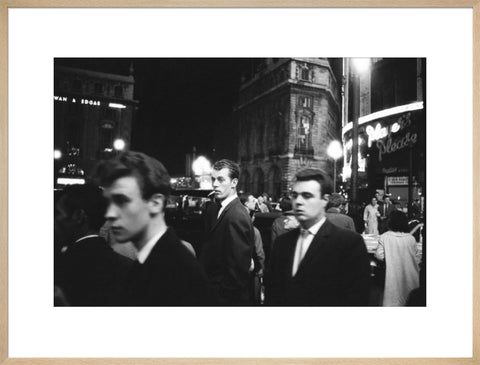 Passers-by on a London street at night c.1955