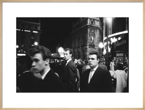 Passers-by on a London street at night c.1955