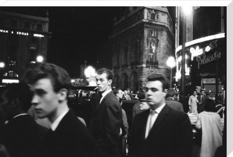 Passers-by on a London street at night c.1955