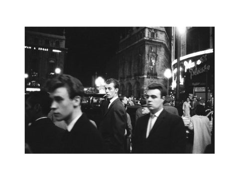 Passers-by on a London street at night c.1955