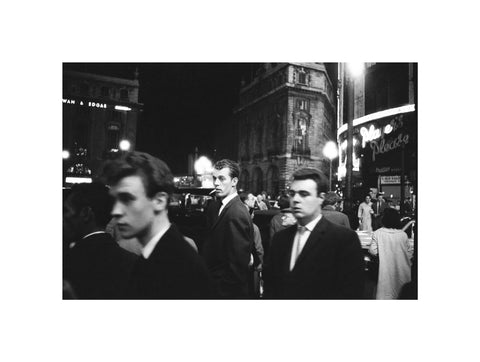 Passers-by on a London street at night c.1955