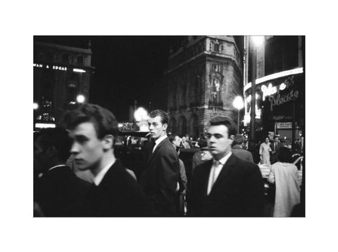 Passers-by on a London street at night c.1955