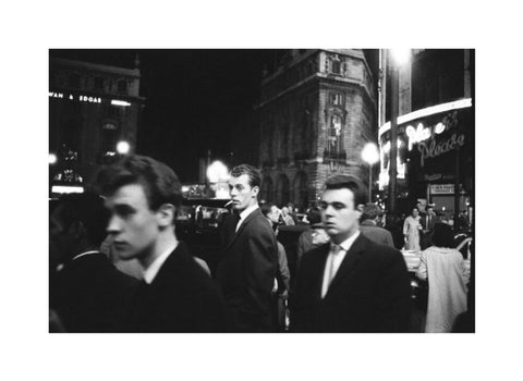 Passers-by on a London street at night c.1955