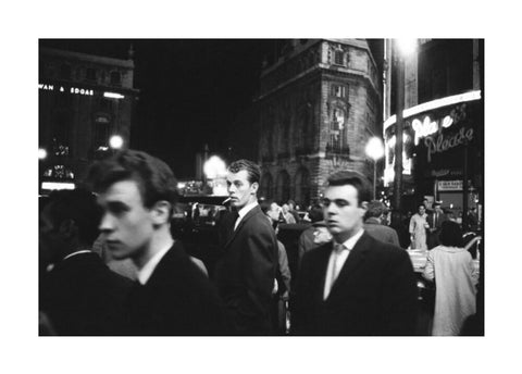 Passers-by on a London street at night c.1955