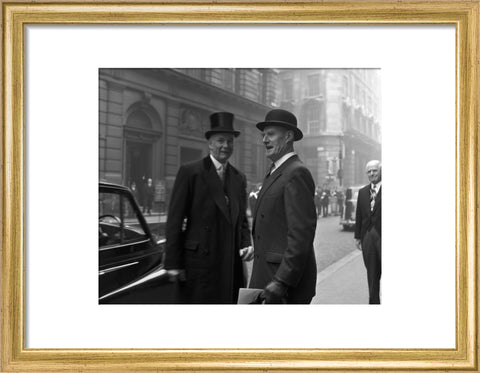 Three formally dressed men on a street flanked by high buildings. c.1955