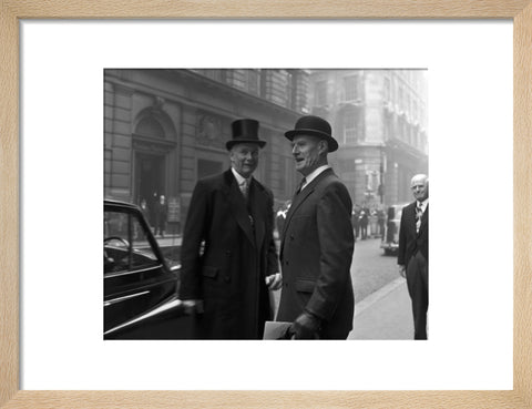 Three formally dressed men on a street flanked by high buildings. c.1955