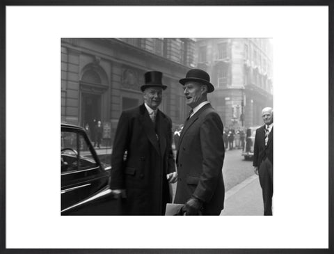 Three formally dressed men on a street flanked by high buildings. c.1955